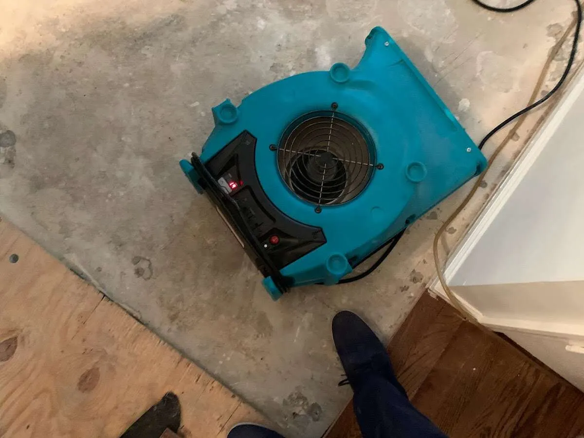 Air mover drying subfloor during Leak Detection & Repair in East Coventry